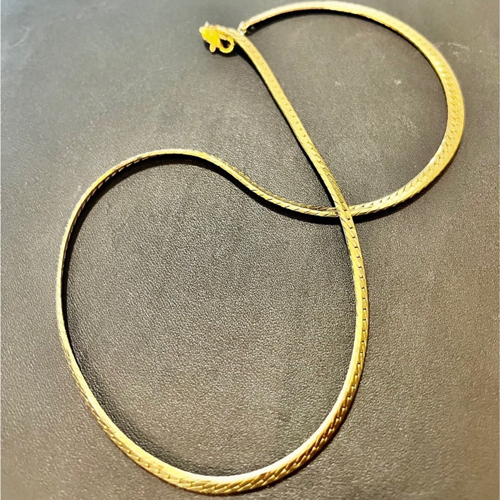 Herringbone chain with  gold tone. Approximately 23 inches.